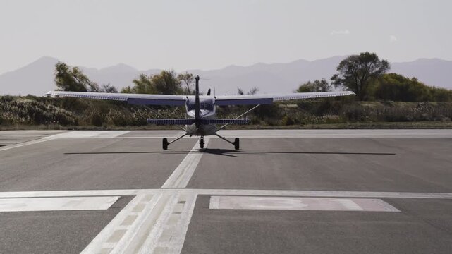 Cessna aircraft slowly moving down runway