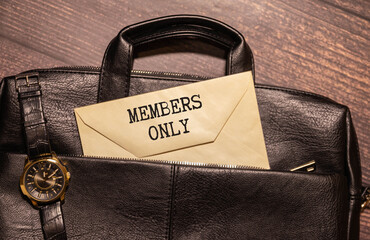 MEMBERS ONLY text on a paper clipboard with chart and notebook on withe background.