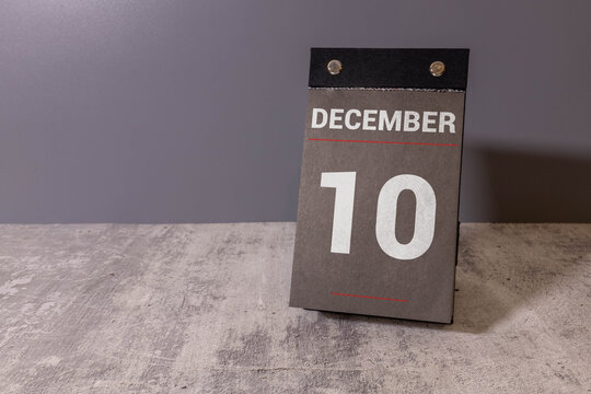 December, 10 on calendar on wooden table close up.