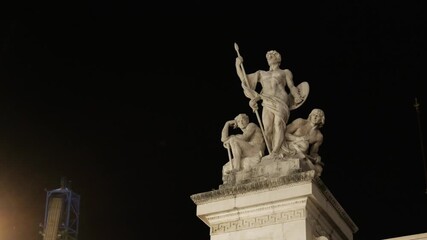 three marble statues monument clearly seen under night lights rome front victor emmanuel ii landmark architecture historic urban scenic nighttime public space 