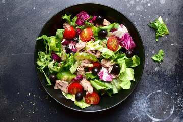 Tuna salad with fresh vegetables. Top view with copy space.