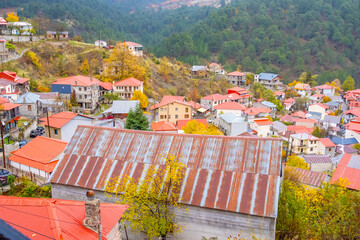 Panoramic High-Angle View of Avdella Village, Grevena, Greece, Nestled in the Misty Pindos Mountains with Traditional Houses and Autumn Foliage