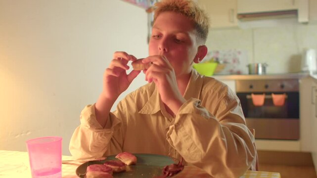 Juvenile cherishing treat during quiet evening, Child relishing biscuit while sipping water peacefully at home