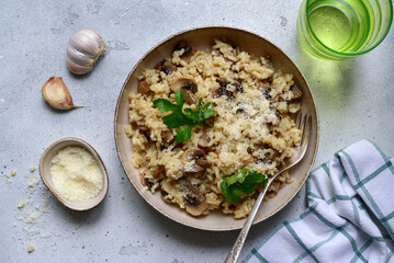 Risotto with mushrooms - tradishional dish of italian cuisine. Top view with copy space.