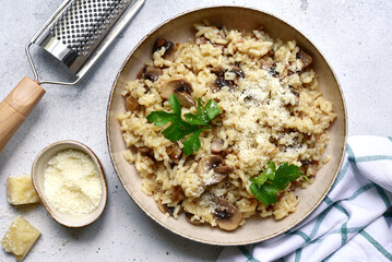 Risotto with mushrooms - tradishional dish of italian cuisine. Top view with copy space.