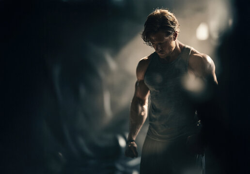 Muscular Man at the gym, focused on his workout