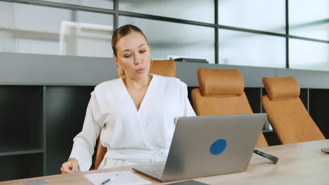 Tired Focused female business consultant holding head, feeling stressed after conversation with client
