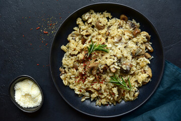 Risotto with mushrooms - tradishional dish of italian cuisine. Top view with copy space.