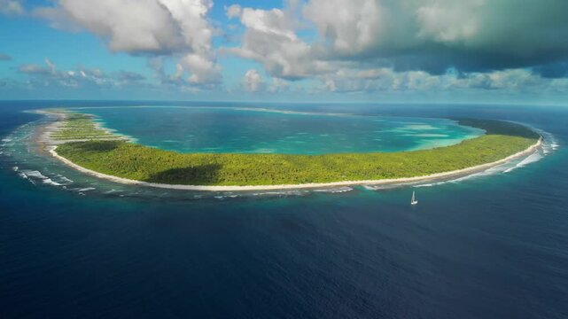 Aerial shot of Orona Atoll with Sailing boat anchor close to reef.
