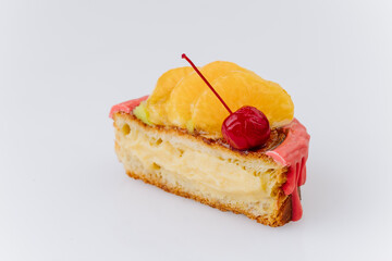 Close-up of a fruit Danish pastry with kiwi, orange slices, and cherry on pink icing