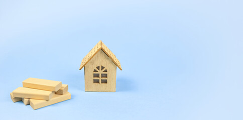 compact wooden home surrounded by tools and building supplies visibly arranged, smallscale wood dwelling positioned among construction equipment and renovation materials clearly exhibited