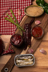 Canned tuna and sardines with fresh ingredients on wood