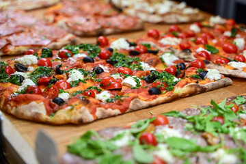 Authentic Italian pizza in a restaurant display window in Rome, Italy.  Different type of traditional Roman styple pizza . 