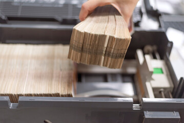 Hand Counting Large Stack of Money in Bank Machine &ndash; Finance and Investment Concept