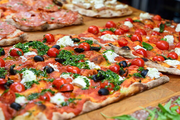 Authentic Italian pizza in a restaurant display window in Rome, Italy.  Different type of traditional Roman styple pizza . 