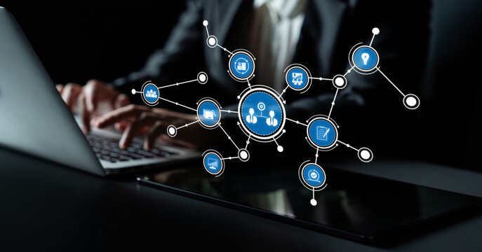 A person engaged in using a laptop, surrounded by virtual icons representing digital connections and networking concepts, emphasizing modern technology and communication. Tessel