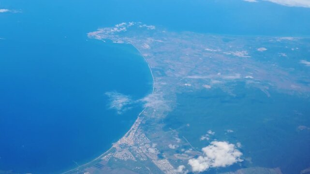 sequence frames towns land meeting ocean blue landscape floating clouds above below during movement to forward top down aerial view civilization structure perspective light altitude 