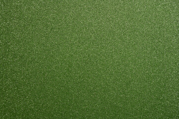 Bright green textured surface with fine glitter particles, ideal for creative projects or background design use
