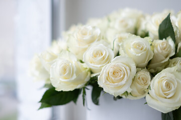White roses arranged beautifully in a decorative bouquet, perfect for celebrations like anniversaries, creating a romantic and elegant atmosphere with soft floral textures