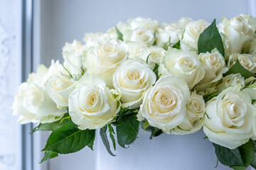 White roses arranged beautifully in a decorative bouquet, perfect for celebrations and anniversaries, creating a serene and elegant background for any occasion