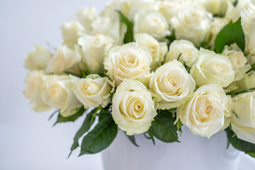 White roses arranged beautifully in a decorative bouquet, perfect for celebrations, anniversaries, and special occasions, creating a serene and elegant background for any event