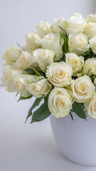 White roses arranged beautifully in a decorative pot create an elegant background for celebrations, perfect for anniversaries and special occasions with floral charm