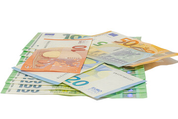 Pile of assorted euro banknotes including one hundred, fifty, twenty, ten and five euro notes scattered on a plain white background, studio shot in tilted view, close-up macrophotography.