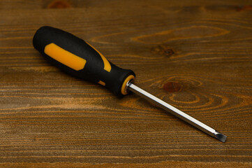 Double-Sided Bit and Screwdriver on Textured Wooden Table in Details