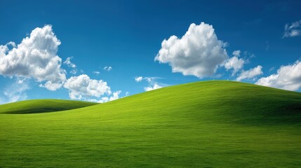 Rolling green hills meet a bright blue sky dotted with fluffy white clouds