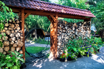 A beautiful garden landscape with a green lawn, hedge, bushes and trees.