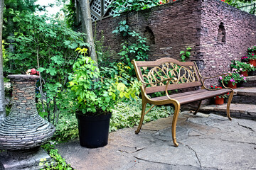 A beautiful garden landscape with a green lawn, hedge, bushes and trees.
