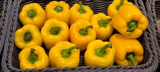 Yellow bell peppers in a fresh vegetable shop