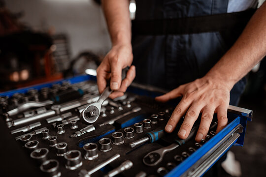 Mechanic organized tools in workshop preparing for vehicle repair work - Powered by Adobe