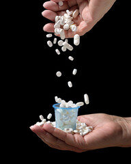 Hand spilling pills. Overmedication concept.