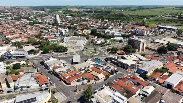 Aerial view of a bustling cityscape with roads, buildings and lush trees