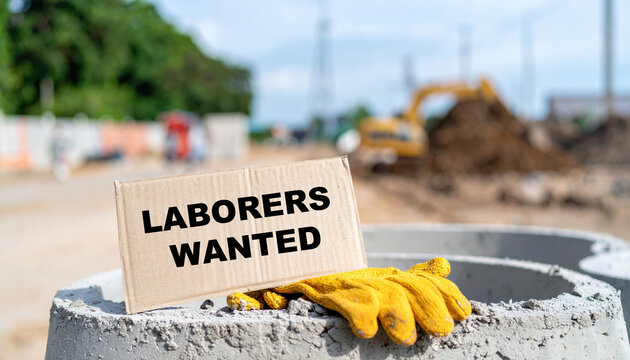 Laborers wanted sign at construction site showing impact of labor market shortages. serious message emphasizes urgent demand for employment and workers