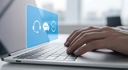 Hands typing on laptop with customer service support symbols displayed on screen