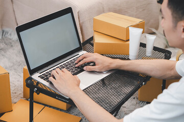 Startup small business owner packing boxes for online customer delivery. Entrepreneur managing...