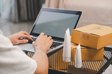 Startup small business owner packing boxes for online customer delivery. Entrepreneur managing...