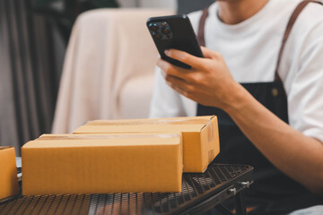 Startup small business owner packing boxes for online customer delivery. Entrepreneur managing...
