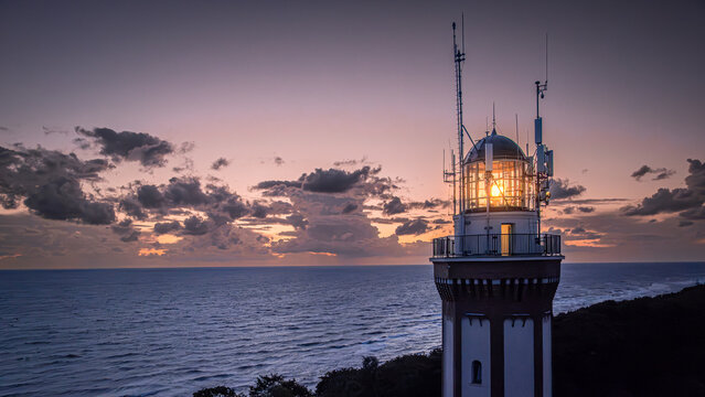 Aerial view of lighthouse after sunset by Baltic Sea. - Powered by Adobe