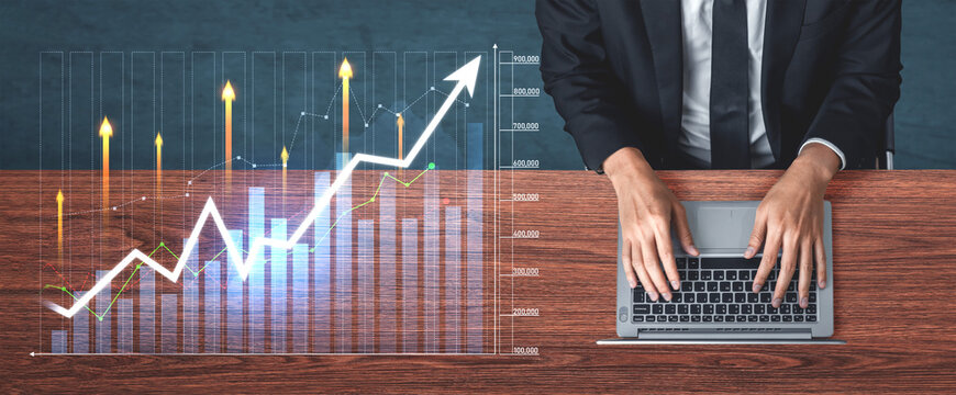Modern workspace featuring a laptop with hands typing and a financial growth chart, illustrating data analysis and upward trends in business success. Scalp - Powered by Adobe