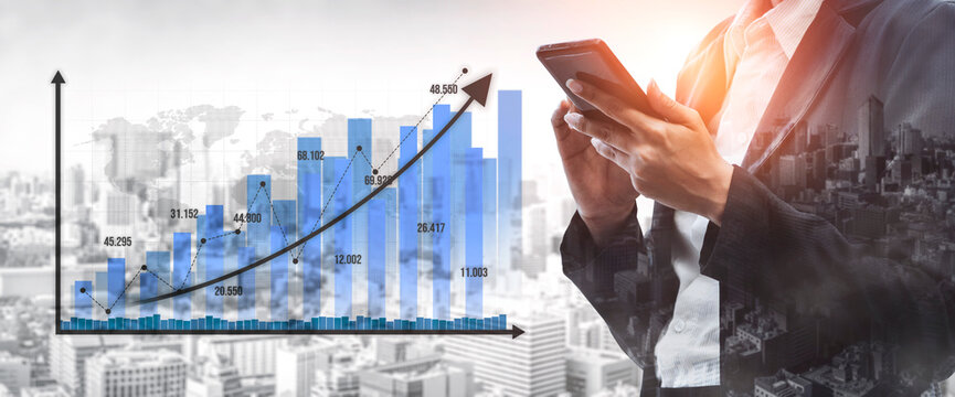 A business professional engages with a smartphone to analyze data while observing rising financial graphs, symbolizing growth and success in a modern urban setting. Tessel