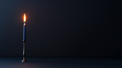 Elegant blue candle burns softly in dark setting creating a warm, peaceful atmosphere