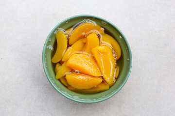 Sliced peaches in syrup served in a bowl