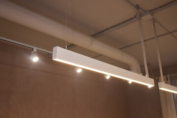 Lighting arrangement emphasizes fixtures and architectural features, Technical adjustments enhance...