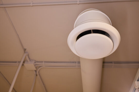 Industrial ceiling design, Contemporary utility ceiling features, Modern commercial ceiling with functional elements, Open ceiling with diffuser pipes and utility components