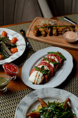 A selection of beautifully presented Georgian dishes is displayed on an elegant table. Fresh ingredients shine, showcasing rich flavors and traditional recipes, inviting everyone to taste the culture