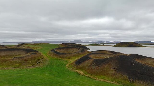 Panning 4K drone aerial footage over volcanic pseudo craters Skutustadagigar in lake Myvatn,Iceland.
