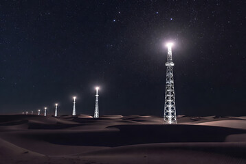 Futuristic towers in desert at night